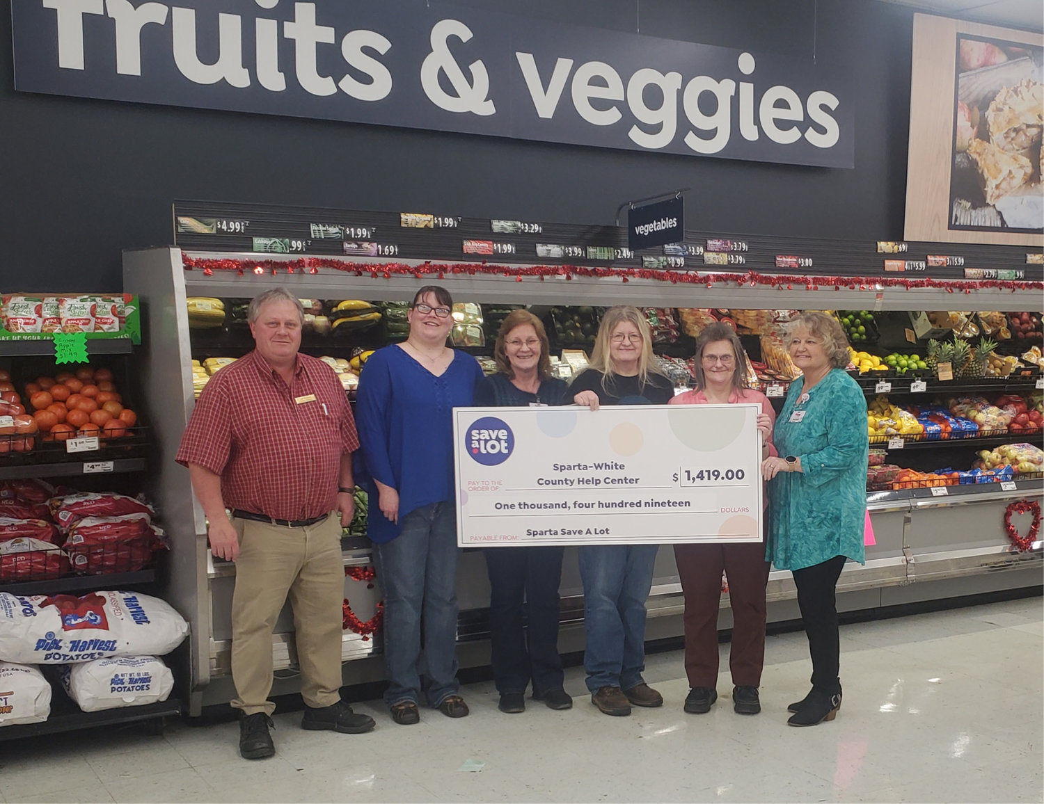 L-R:  District Manager Jeff Ashford, Store manager Sabrina Gay, Assistant Manager Donna Measles, Sparta-White County Help Center representative Melissa Quinn, Manager Jackie Brock, Manager Vickie Young